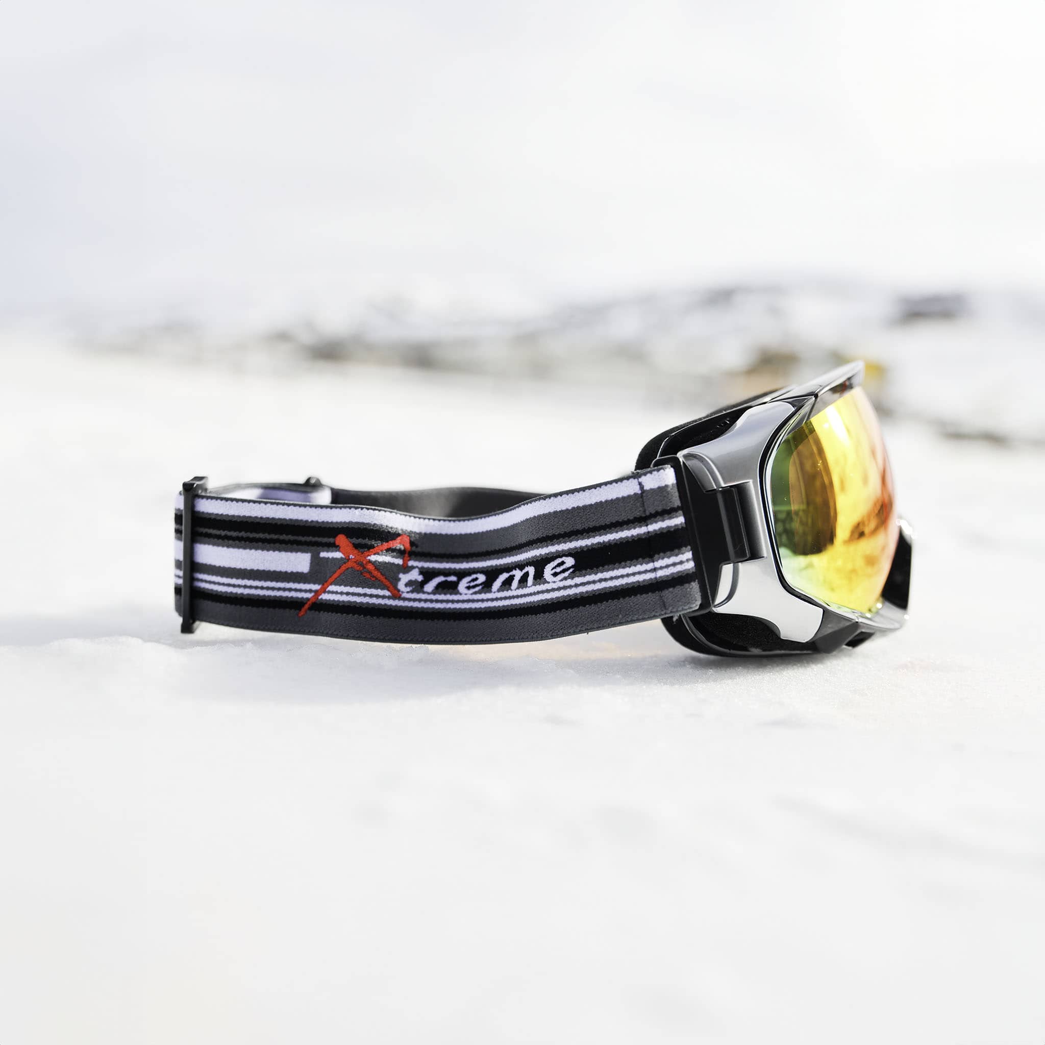 Xtreme Mirrored Adult Snow Goggles in black, side view, REVO red mirrored lens, low-bridge fit